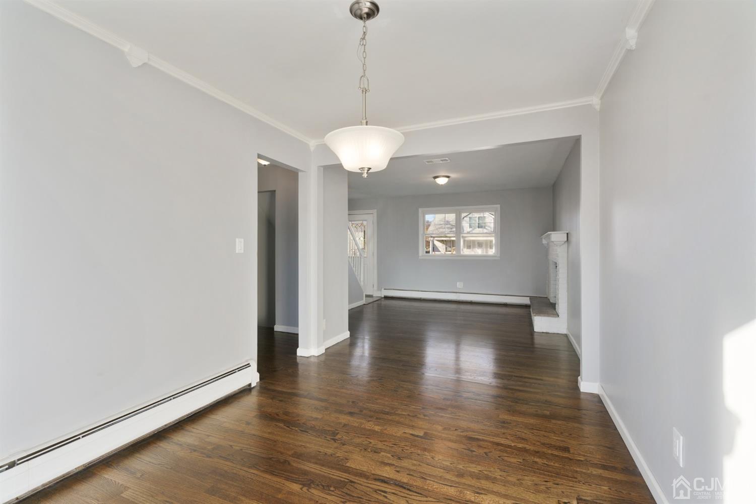 403 Fulton Street Middlesex, NJ 08846 - Photo 3 of 31 a view of an empty room with wooden floor and a window