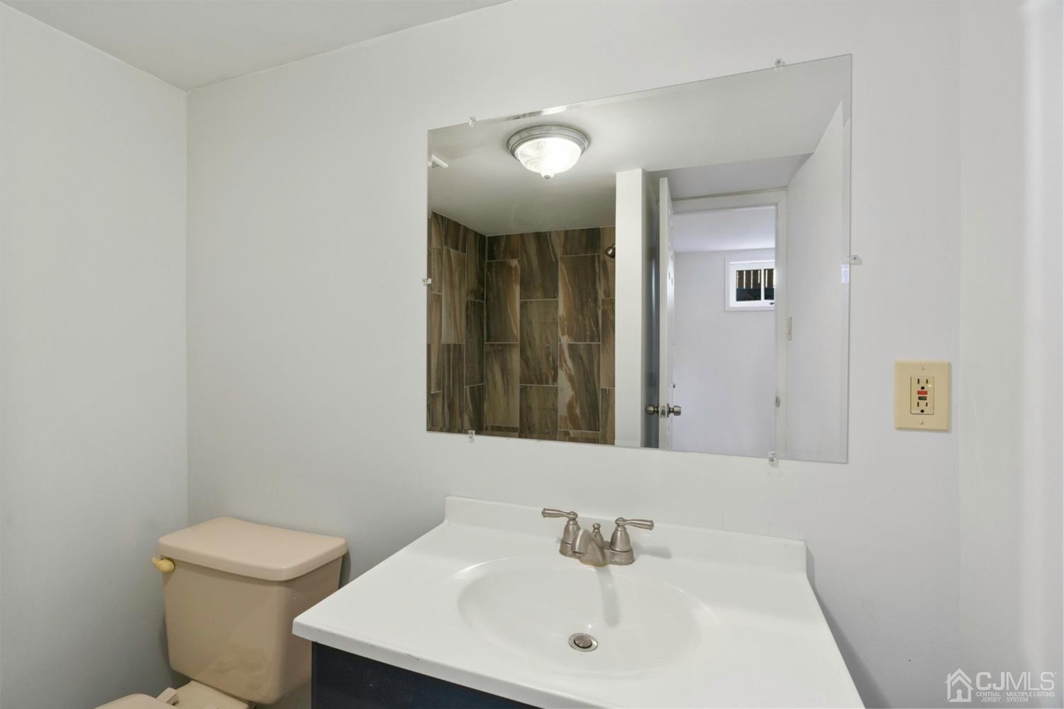 403 Fulton Street Middlesex, NJ 08846 - Photo 22 of 31 a bathroom with a toilet a sink and mirror