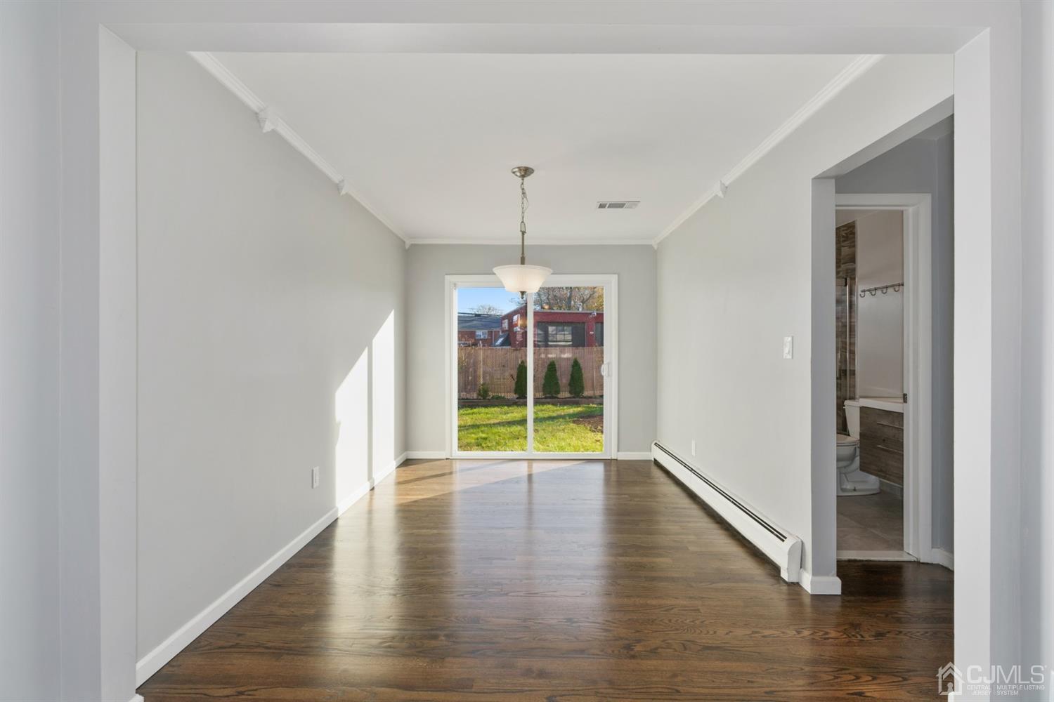 403 Fulton Street Middlesex, NJ 08846 - Photo 6 of 31 a view of an empty room with wooden floor