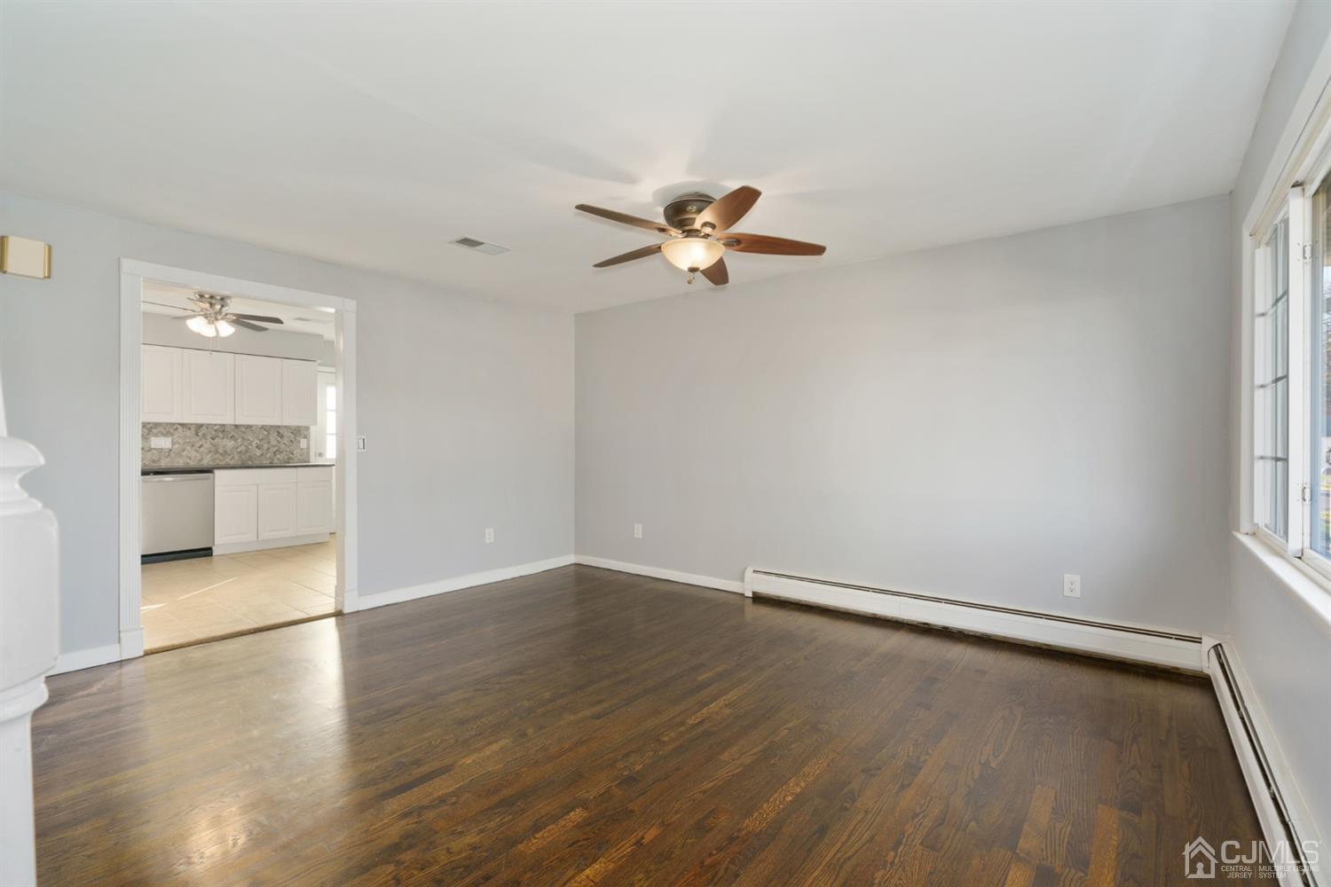 403 Fulton Street Middlesex, NJ 08846 - Photo 10 of 31 wooden floor in an empty room with a window