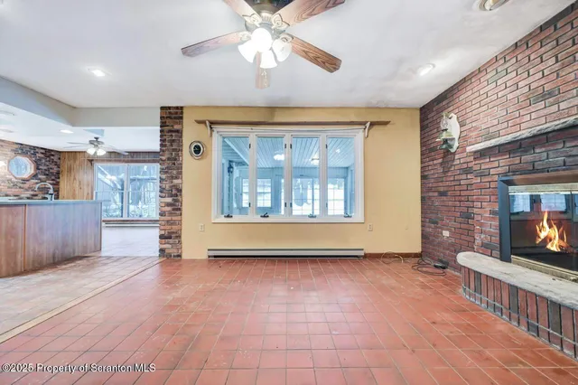 a open kitchen with a refrigerator and microwave