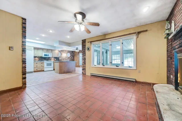 a view of a kitchen with a sink and a refrigerator