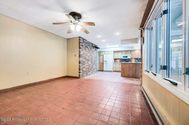 a view of an empty room with a fireplace