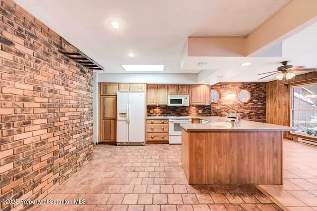 a kitchen with stainless steel appliances a refrigerator sink microwave and stove