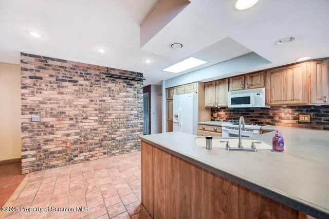 a kitchen with a sink stove and microwave