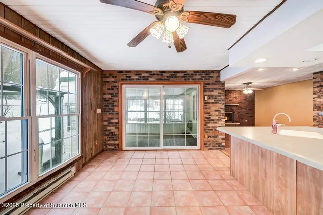 a kitchen with granite countertop a sink a stove and a wooden cabinets