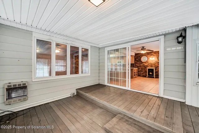 a view of a hallway with wooden shelves