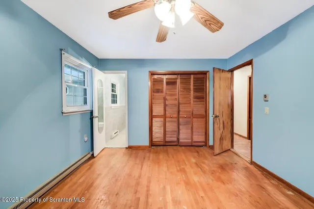 a bathroom with a granite countertop toilet sink and mirror