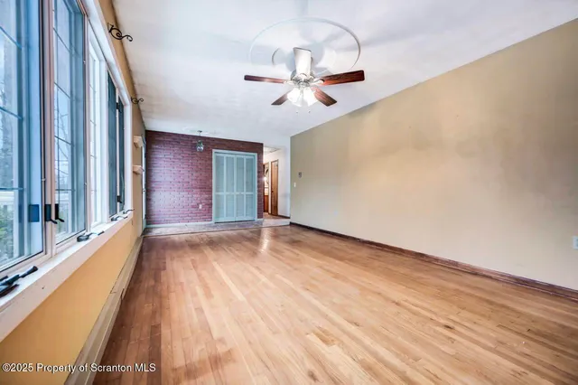 a large white kitchen with granite countertop a sink cabinets and stove top oven
