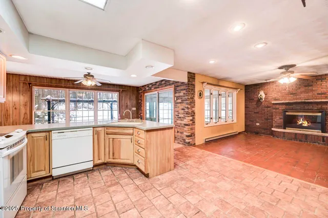 a view of an empty room with a fireplace and a window