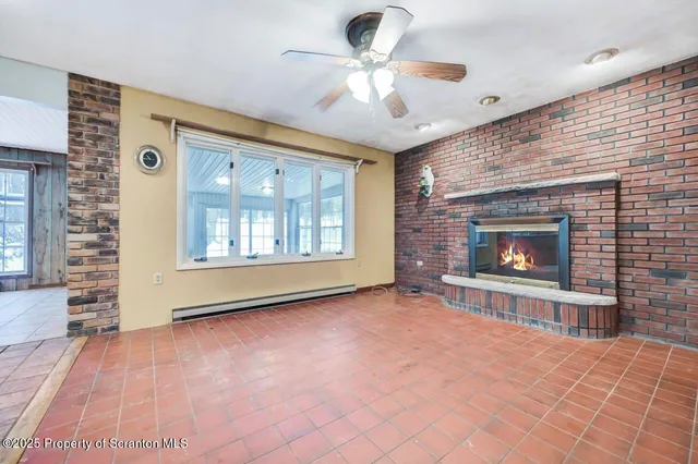 a view of livingroom with hardwood floor and a ceiling fan