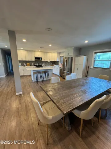 a living room with stainless steel appliances furniture