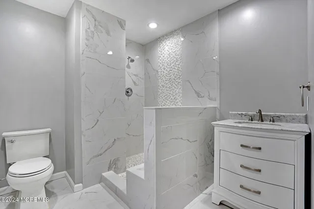 a bathroom with a sink toilet and shower