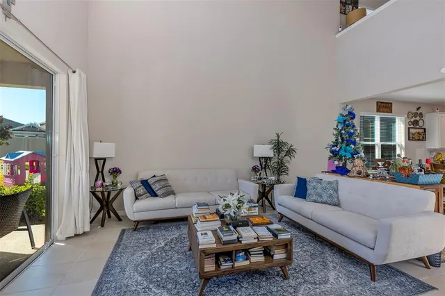 a living room with furniture and a chandelier