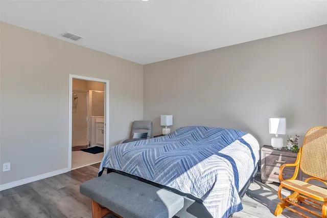 a bed sitting in a bedroom next to a window