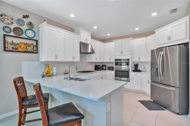 a dining room with furniture and a floor to ceiling window