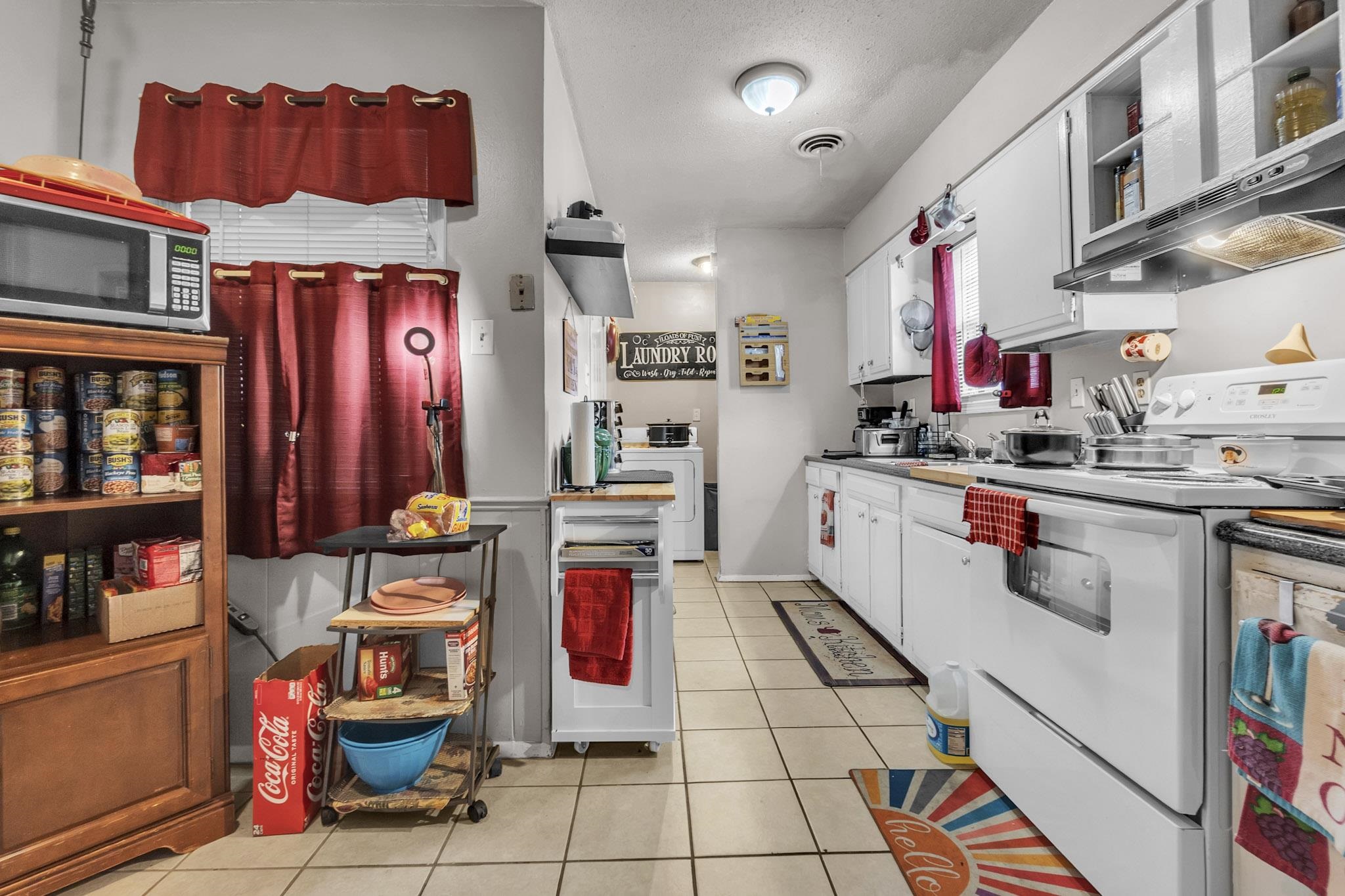 4905 Fernbrook Drive Memphis, TN 38118 - Photo 4 of 9 a kitchen with stainless steel appliances kitchen island granite countertop a sink and cabinets
