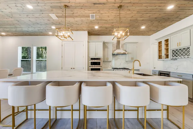 a kitchen with stainless steel appliances granite countertop a refrigerator and cabinets