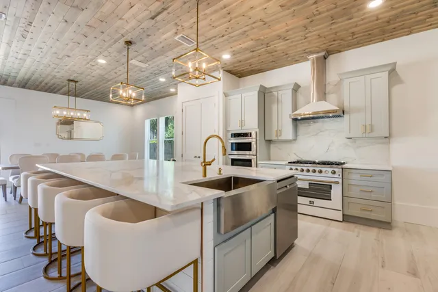 a kitchen with stainless steel appliances a refrigerator and cabinets