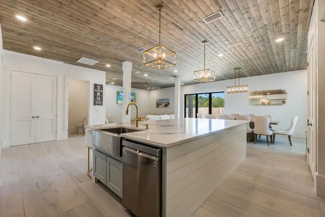 a kitchen with white cabinets and appliances