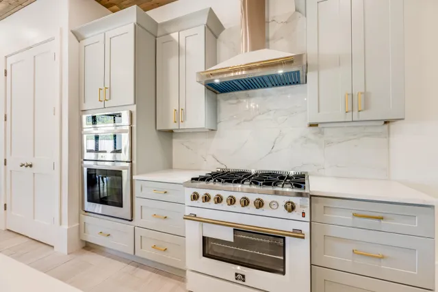 a kitchen with stainless steel appliances granite countertop a stove and a microwave