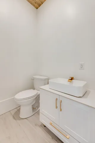 a view of a hallway with wooden floor and entryway