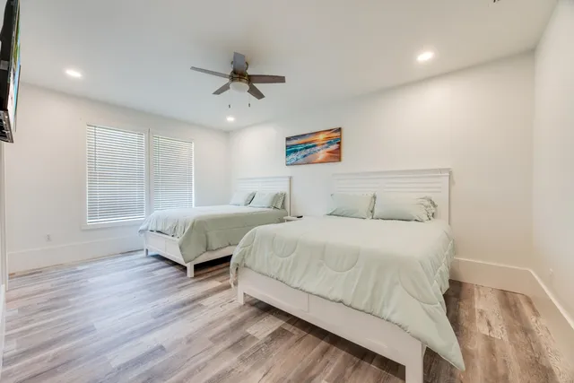 an aerial view of a house with swimming pool and large trees