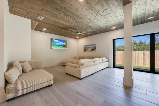a living room with furniture and a wall painting