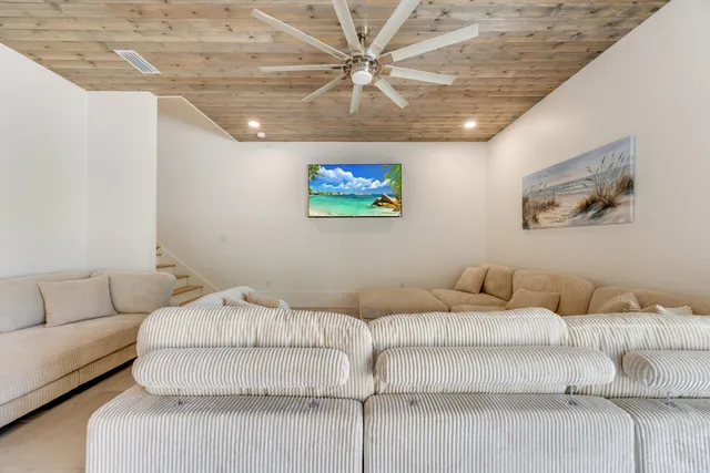 a spacious bedroom with a bed and a chandelier