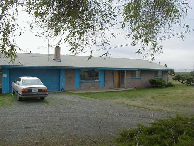 2330 West Wapato Road Wapato, WA 98951 - Photo 1 of 1 a car parked in front of white house