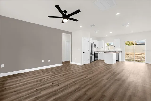 a view of a kitchen with a sink and wooden floor