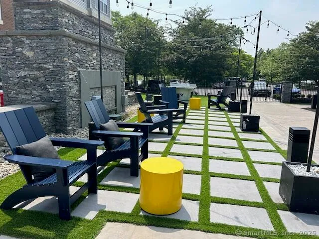a view of a patio with table and chairs and potted plants