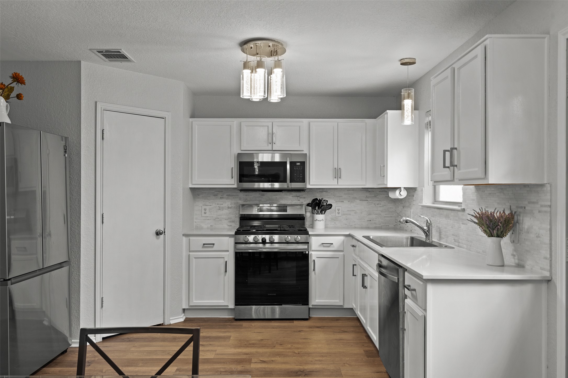 4529 Best Way Austin, TX 78725 - Photo 12 of 33 a kitchen with cabinets stainless steel appliances and a counter space