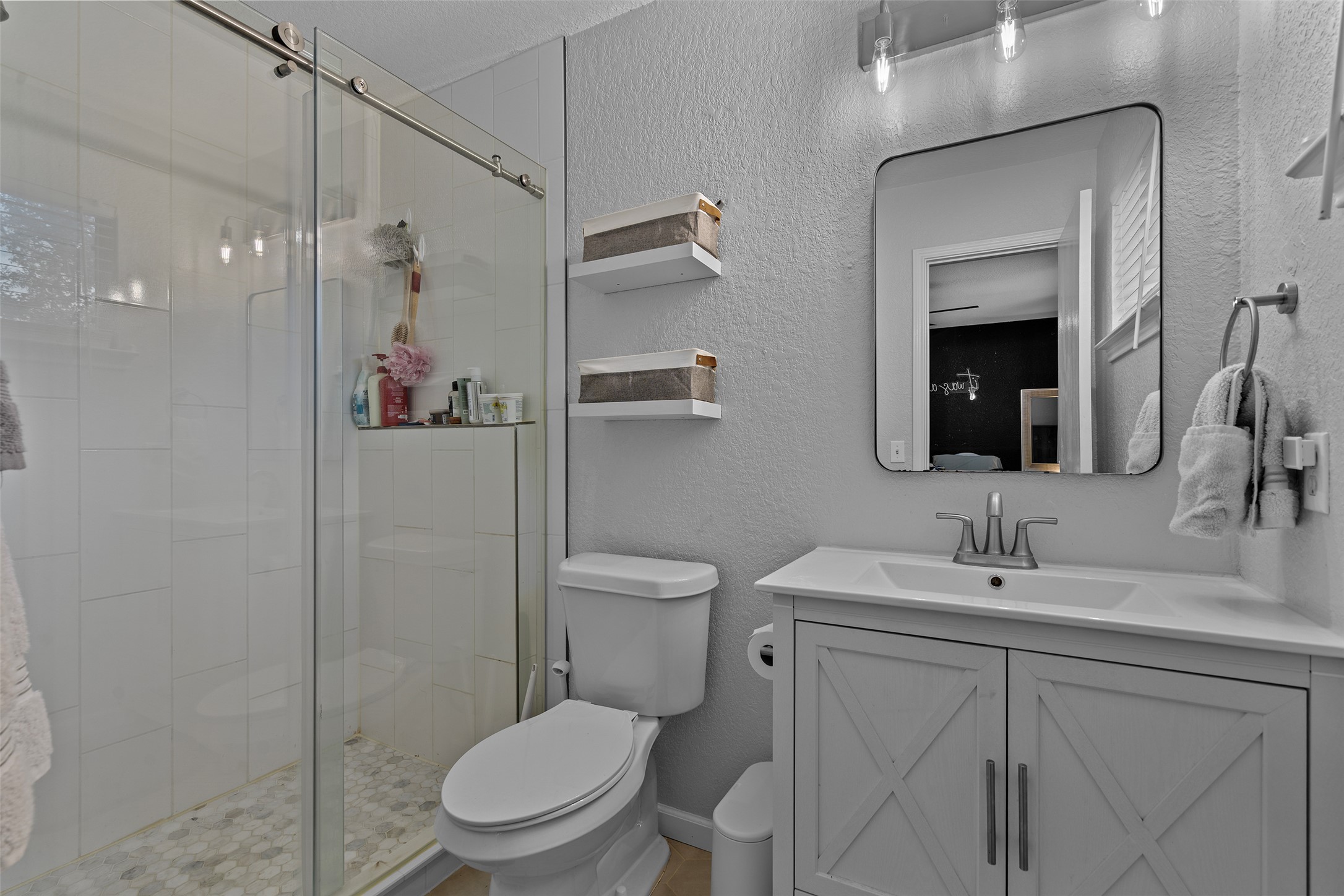 4529 Best Way Austin, TX 78725 - Photo 26 of 33 a bathroom with a toilet sink vanity and mirror