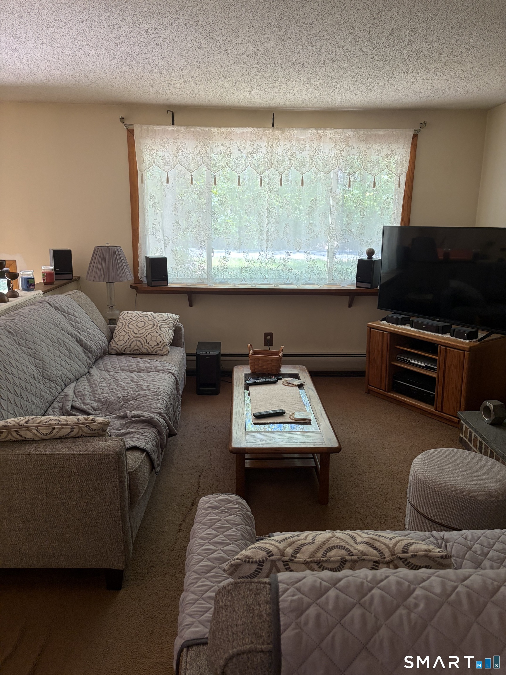 109 Village Hill Road Willington, CT 06279 - Photo 15 of 22 a living room with furniture and a flat screen tv