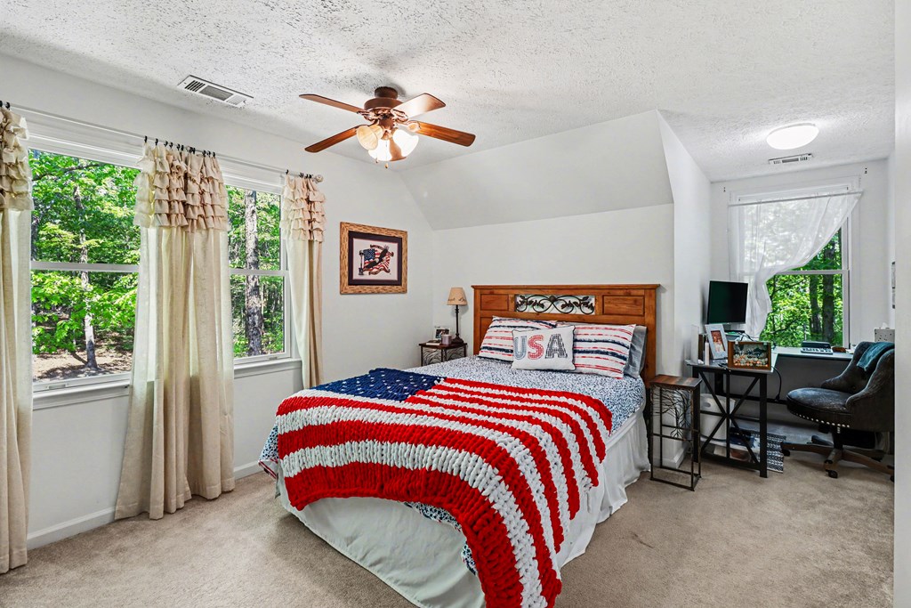 1136 Timber Ridge Lane Ellijay, GA 30540 - Photo 23 of 36 a bedroom with a bed and a window