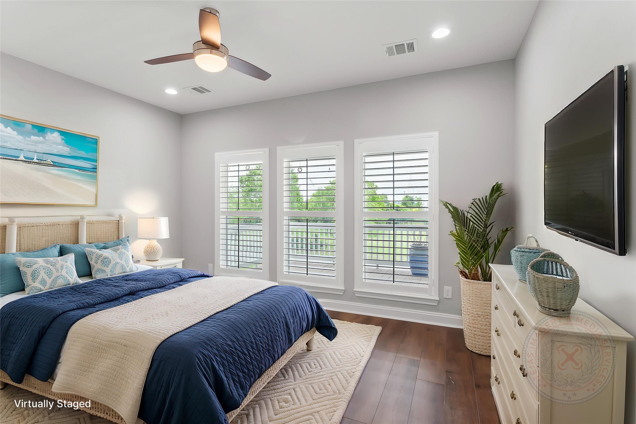 610 South Shady Lane La Porte, TX 77571 - Photo 19 of 50 This photo showcases a bright, modern bedroom with large windows, shutters, and a ceiling fan.
