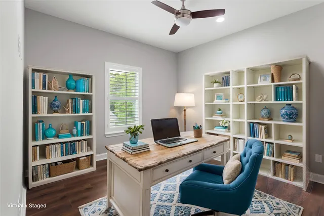 a view of a workspace with furniture and a bookshelf
