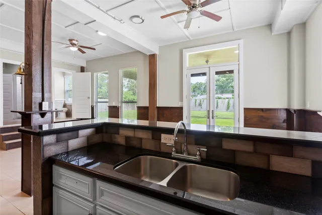 a kitchen with a sink and large window