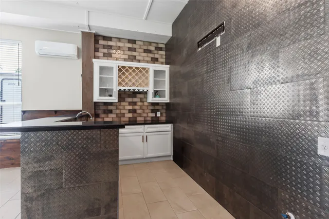a bathroom with a granite countertop sink a large mirror and a shower