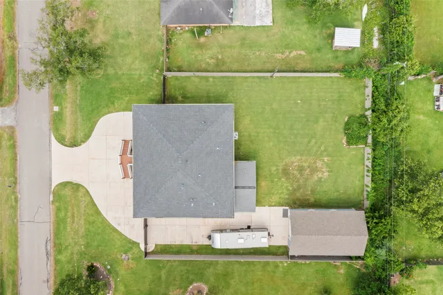 an aerial view of a house with a garden and swimming pool