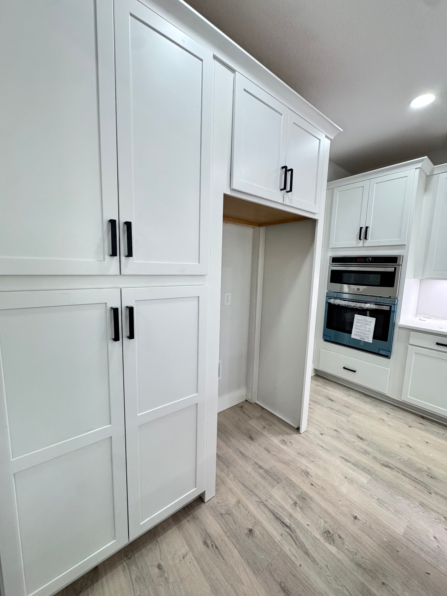 1725 Powell Road Clarksville, TN 37043 - Photo 12 of 42 a view of a kitchen with wooden floor and electronic appliances
