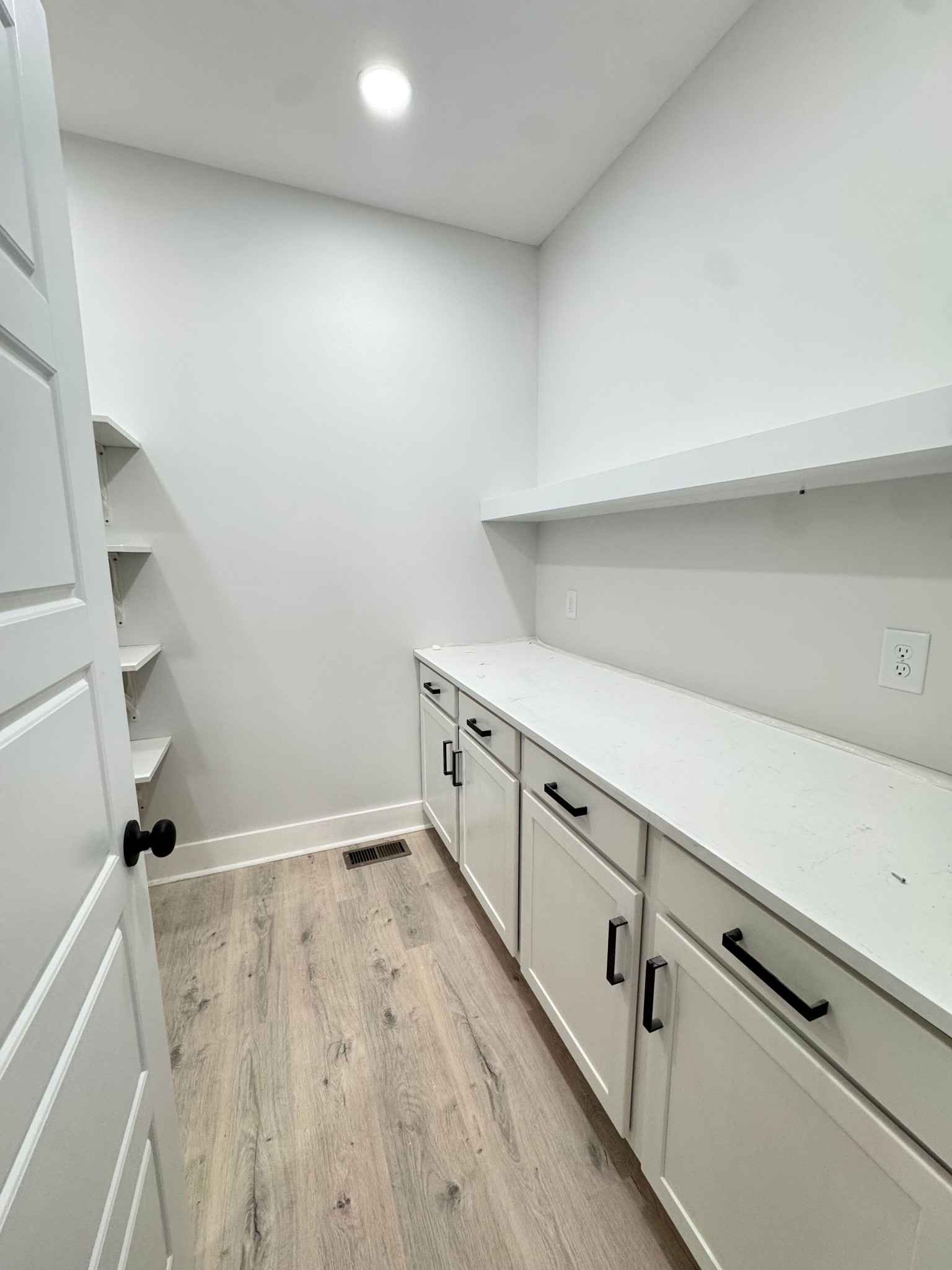 1725 Powell Road Clarksville, TN 37043 - Photo 17 of 42 a kitchen with white cabinets and wooden floor