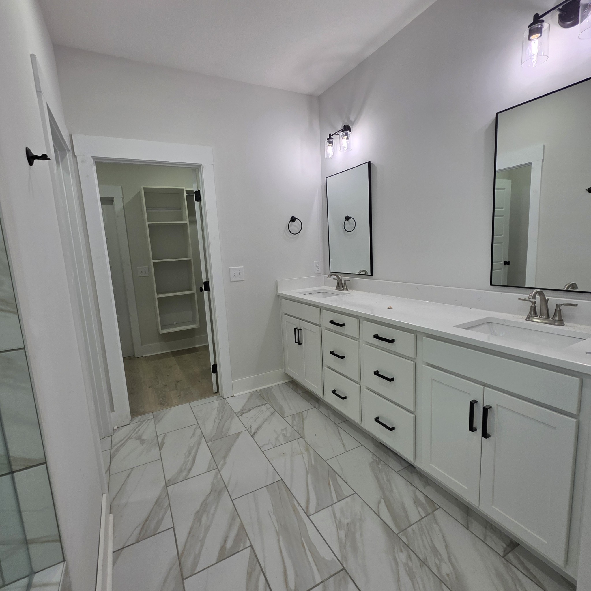 1725 Powell Road Clarksville, TN 37043 - Photo 36 of 58 a spacious bathroom with a double vanity sink a mirror and a