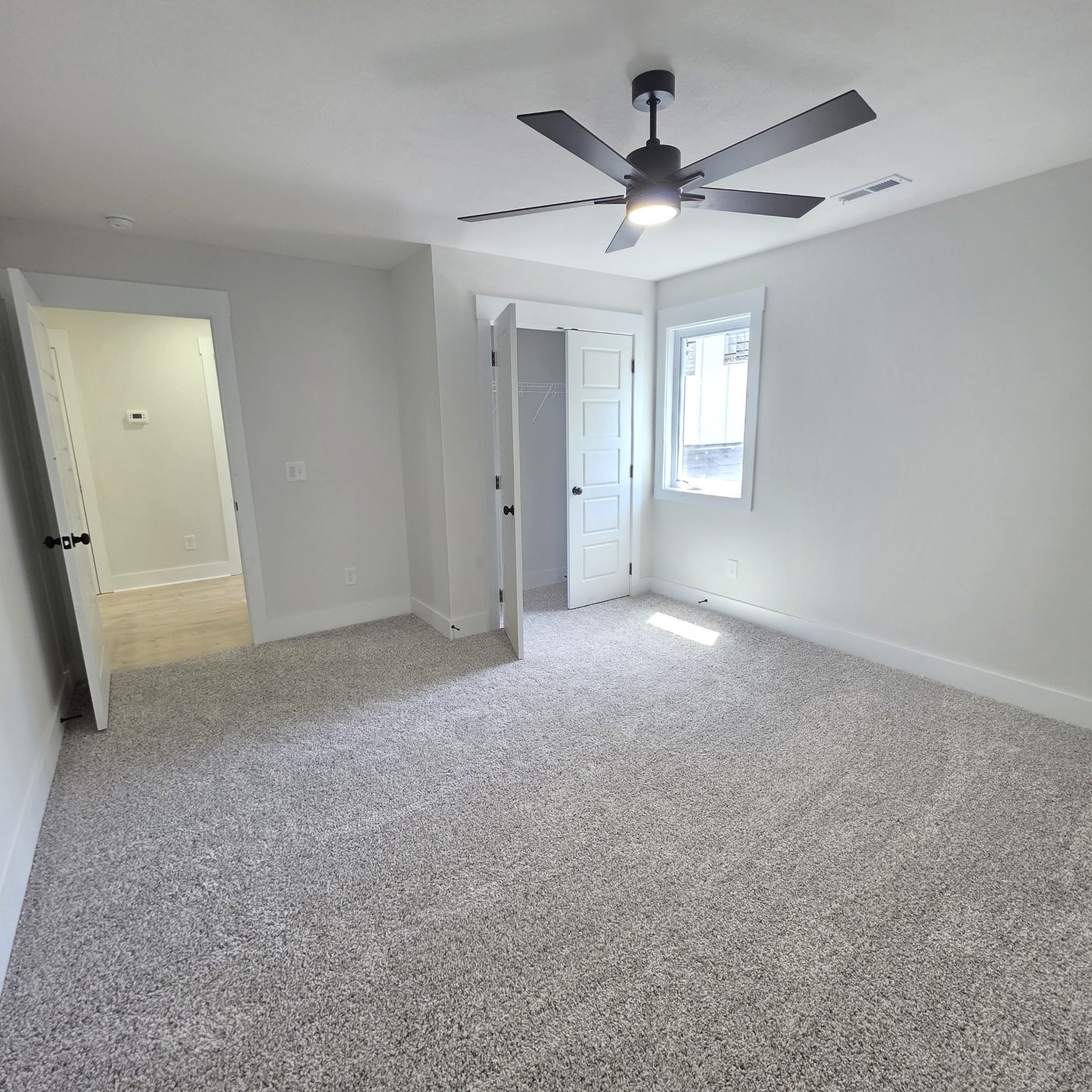 1725 Powell Road Clarksville, TN 37043 - Photo 47 of 58 an empty room with a ceiling fan and a large window