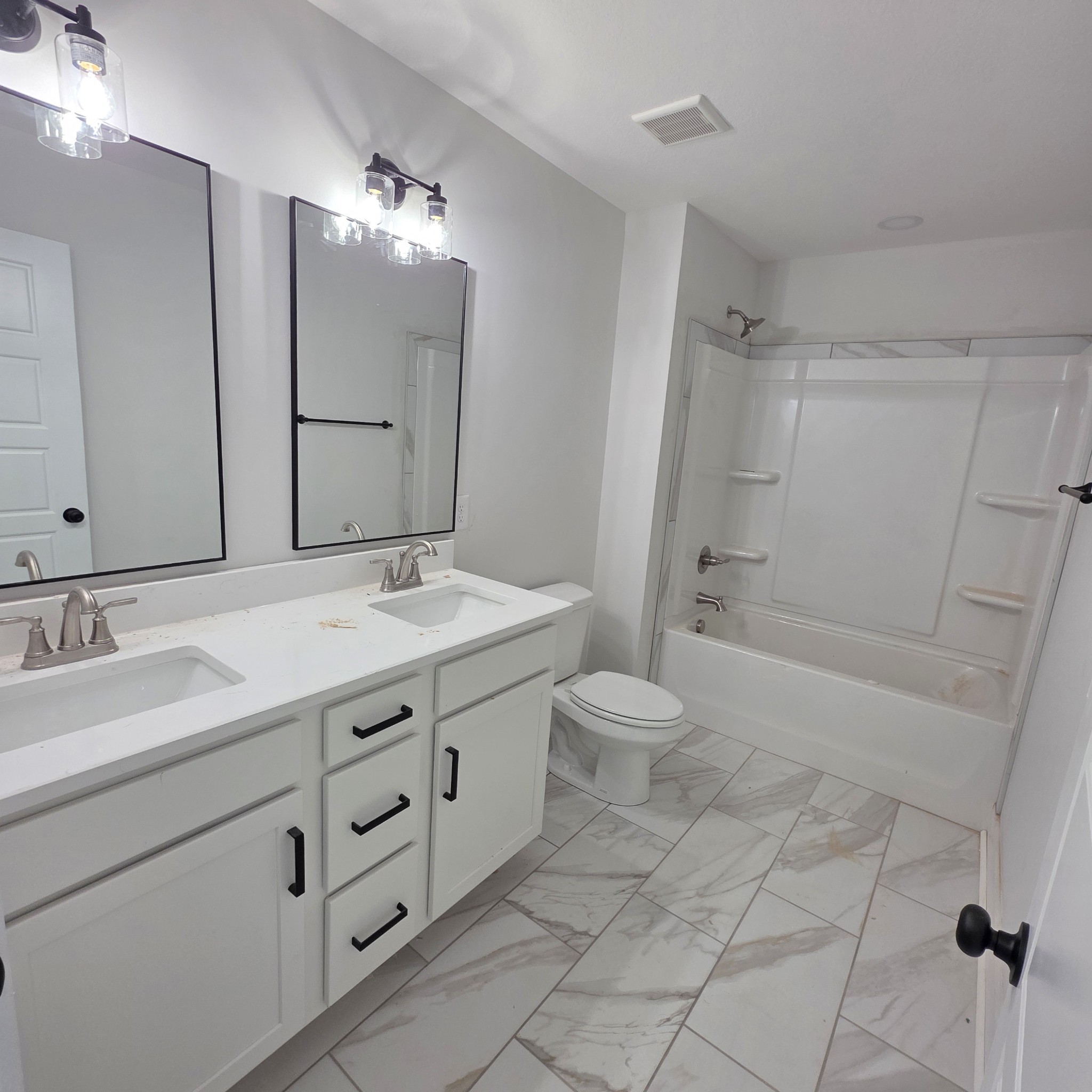 1725 Powell Road Clarksville, TN 37043 - Photo 48 of 58 a bathroom with a double vanity sink toilet and shower