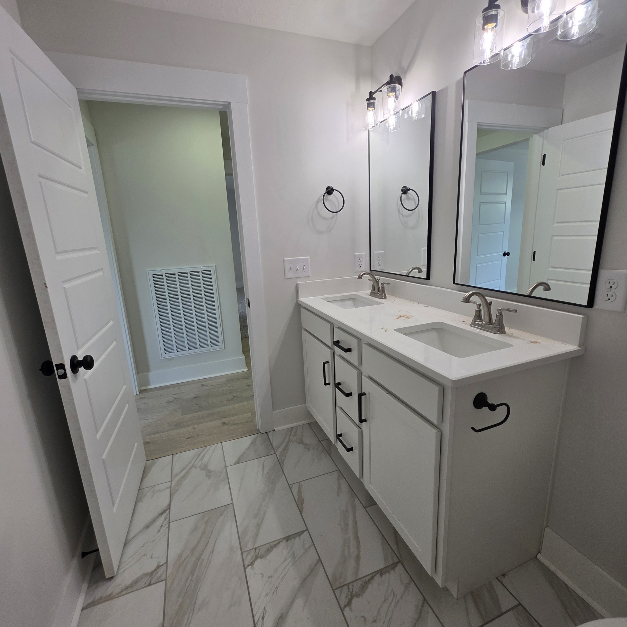 1725 Powell Road Clarksville, TN 37043 - Photo 49 of 58 a bathroom with a sink a mirror a vanity and a shower