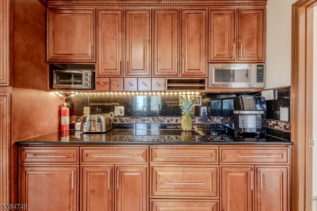 a kitchen with stainless steel appliances granite countertop a refrigerator and cabinets