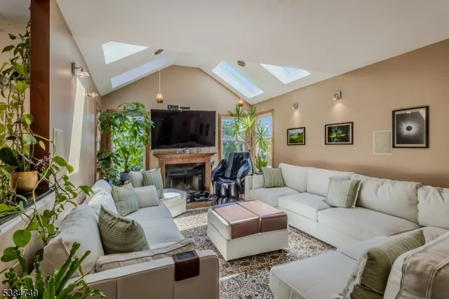 a living room with furniture a large window and a fireplace