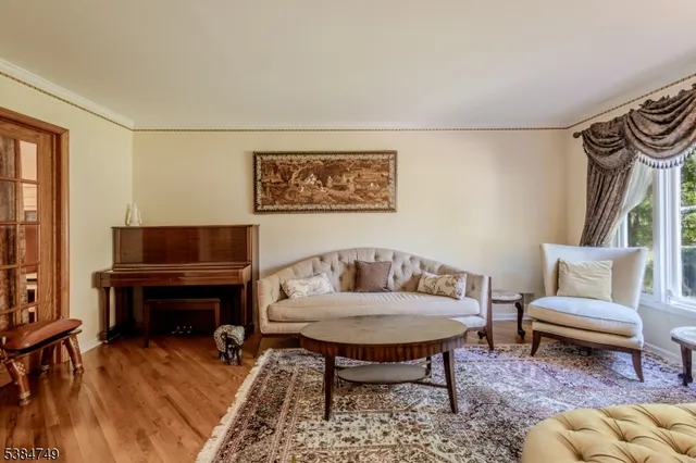 a living room with furniture and a piano